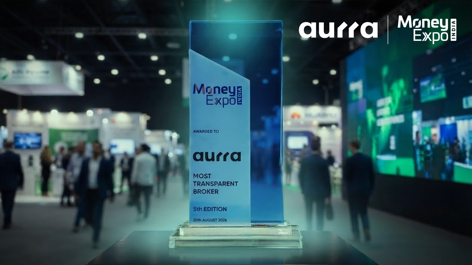 Aurra Markets receives the “Most Transparent Broker” award at Money Expo Mumbai 2026, featuring the award trophy in the foreground with the expo venue blurred in the background.